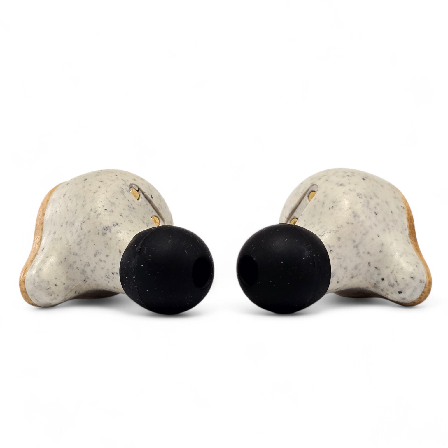 Close-up of PureBuds Pro bamboo earbuds showing the silicone ear tips and wheat straw plastic