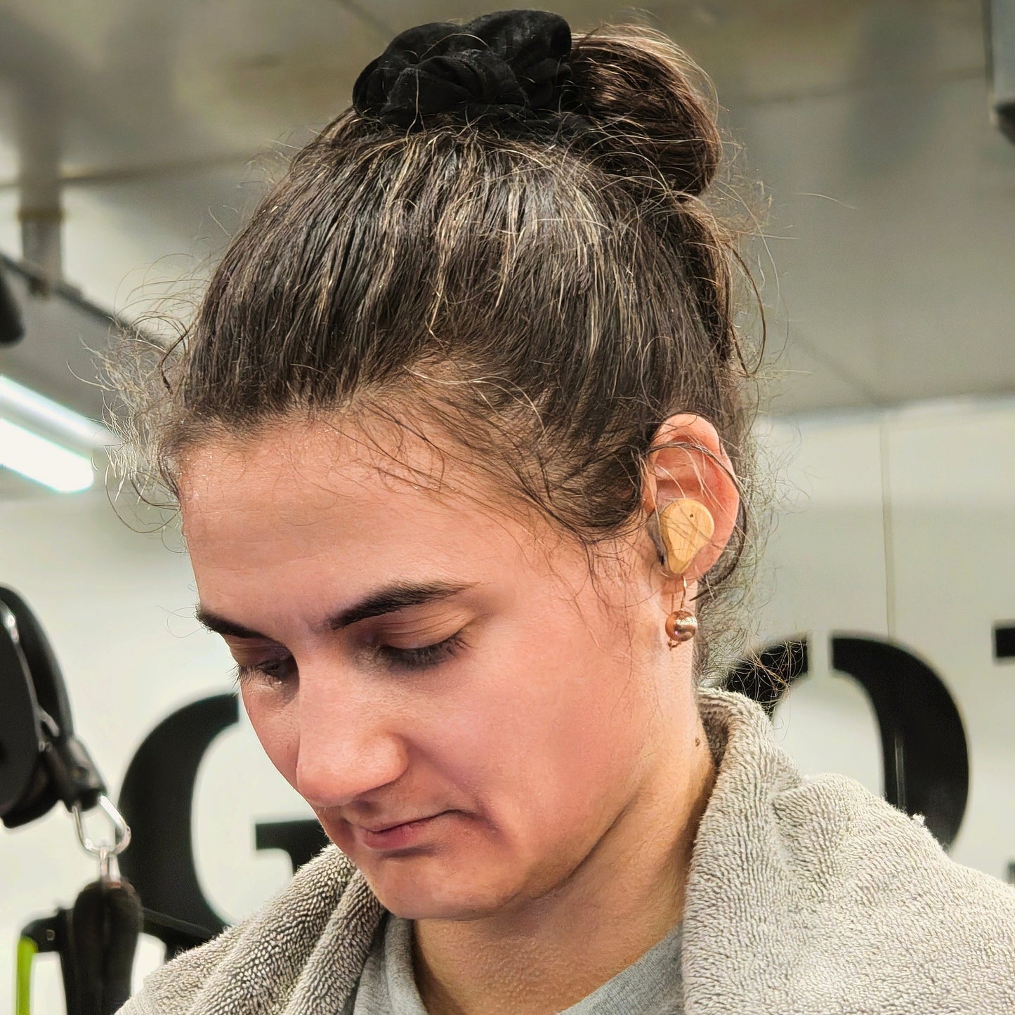 Person wearing PureBuds Pro Earbuds in a gym setting
