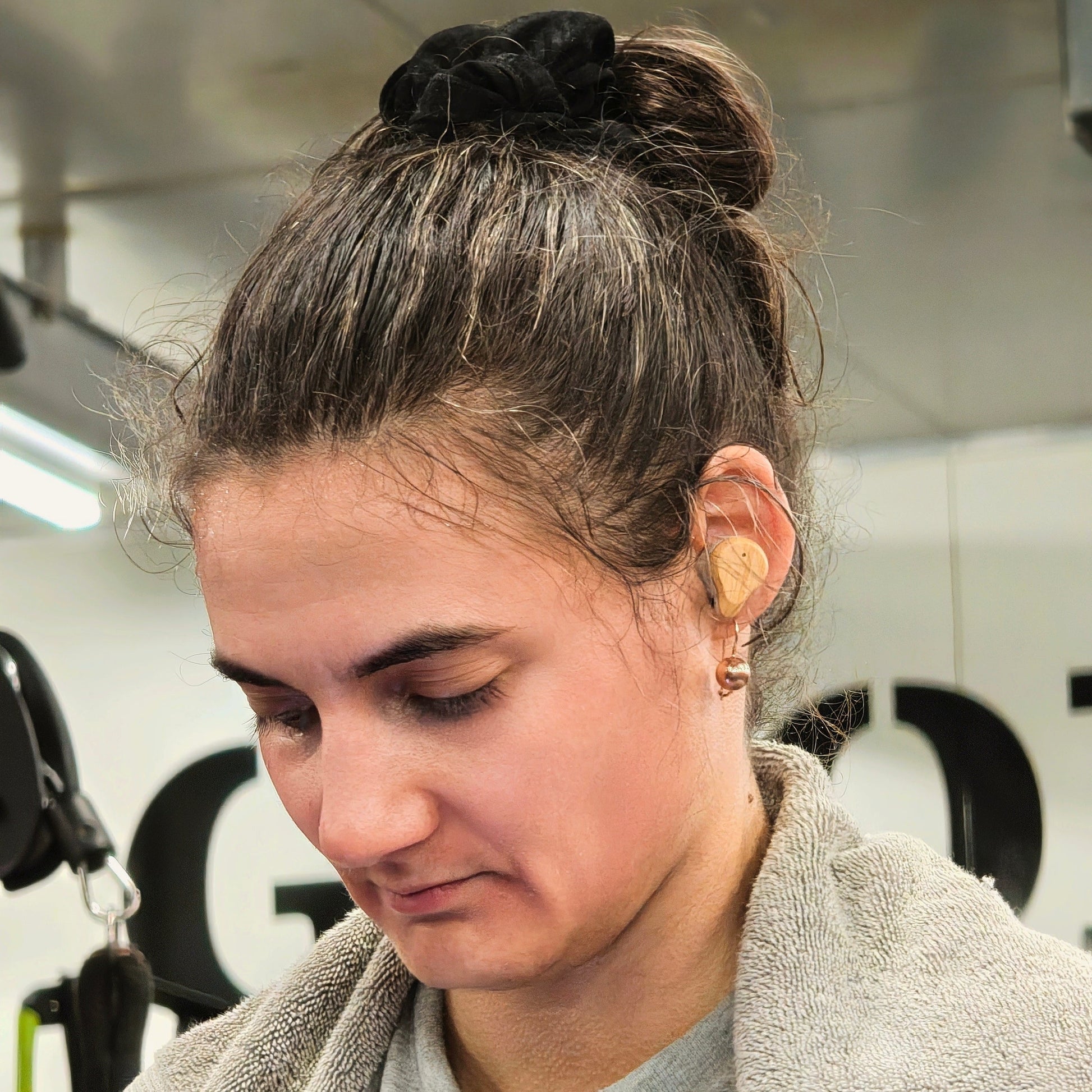 Person wearing PureBuds Pro Earbuds in a gym setting