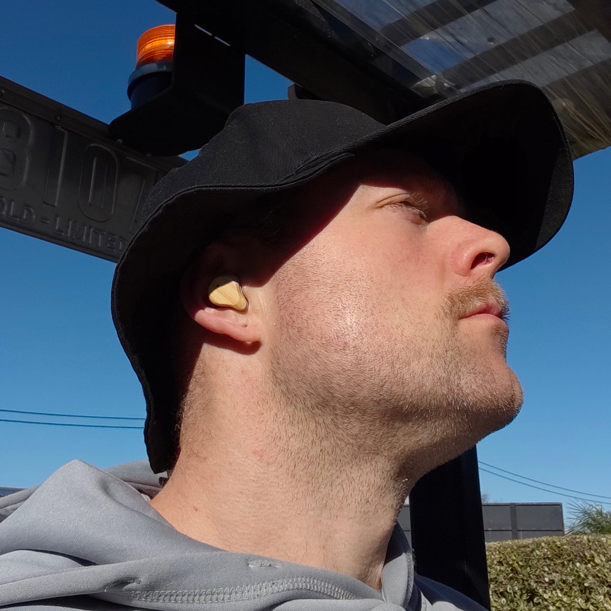 Man wearing PureBuds Pro earbuds at work 