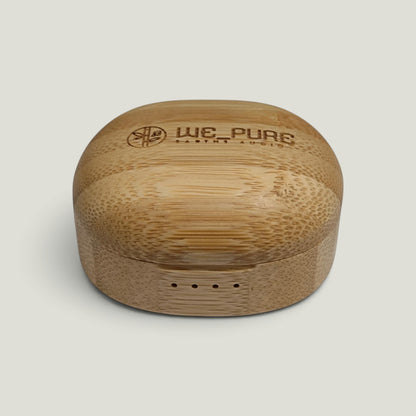 We Pure bamboo charging case for PurePods earbuds with natural wood grain texture and engraved brand logo.