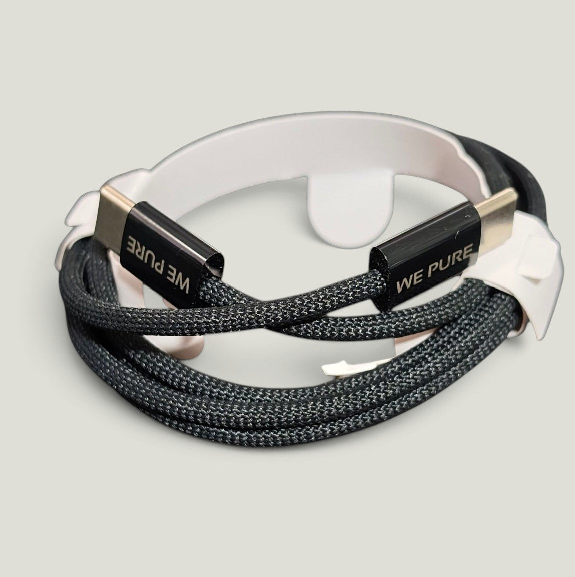 We Pure braided nylon USB-C to USB-C cable with laser-engraved black metal connectors for 100W fast charging.