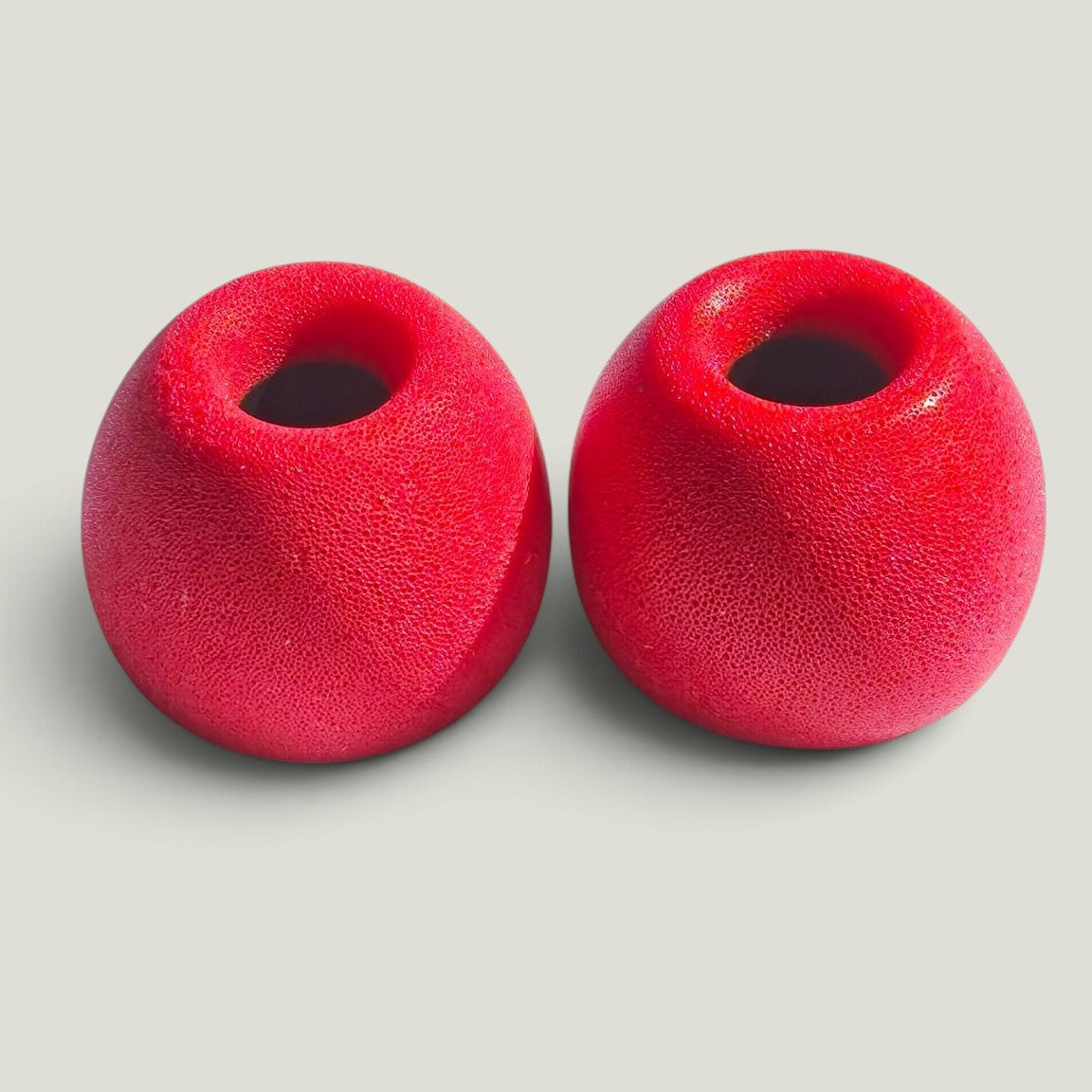 We Pure memory foam ear tips in Tradie Red, designed for a secure noise-blocking seal with PureBuds Pro earbuds.