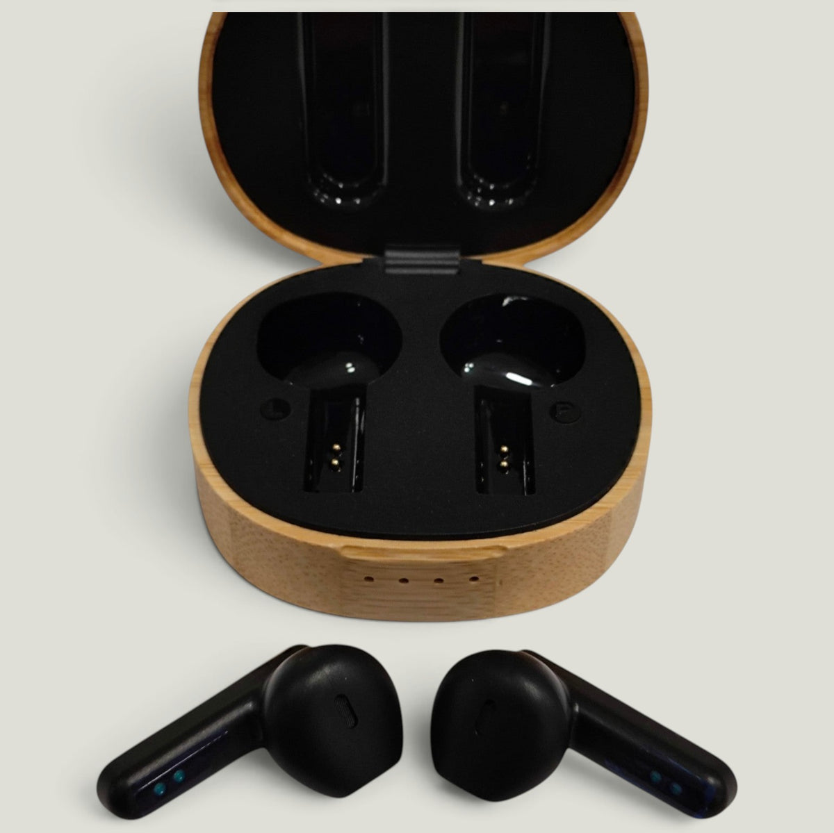 We Pure PurePods open-fit earbuds in black with a sustainable bamboo charging case on a neutral background.