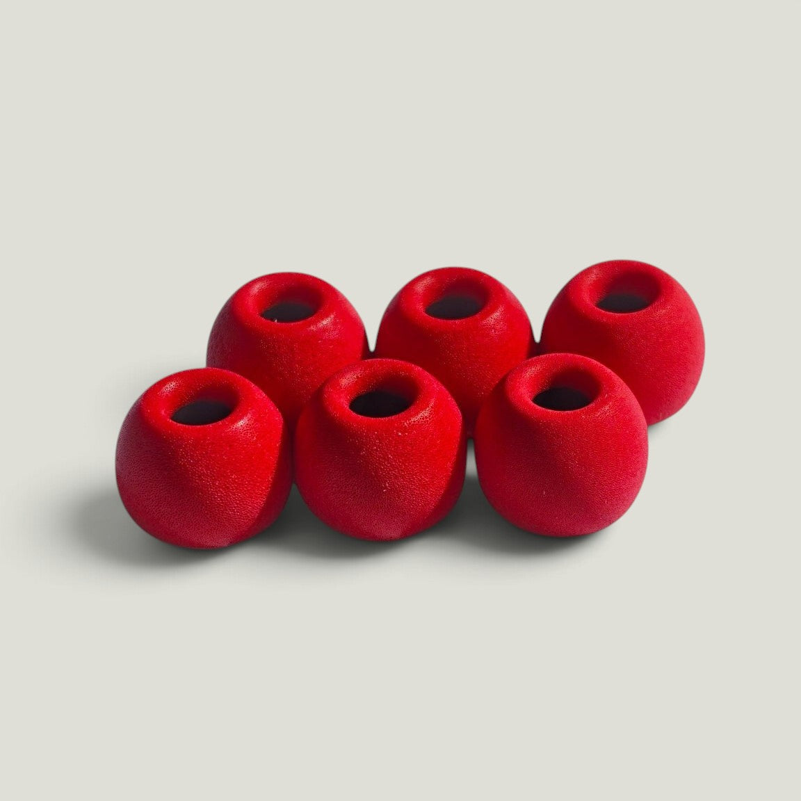 Three pairs of We Pure PureSeal memory foam ear tips in Tradie Red, designed for a secure noise-blocking seal.