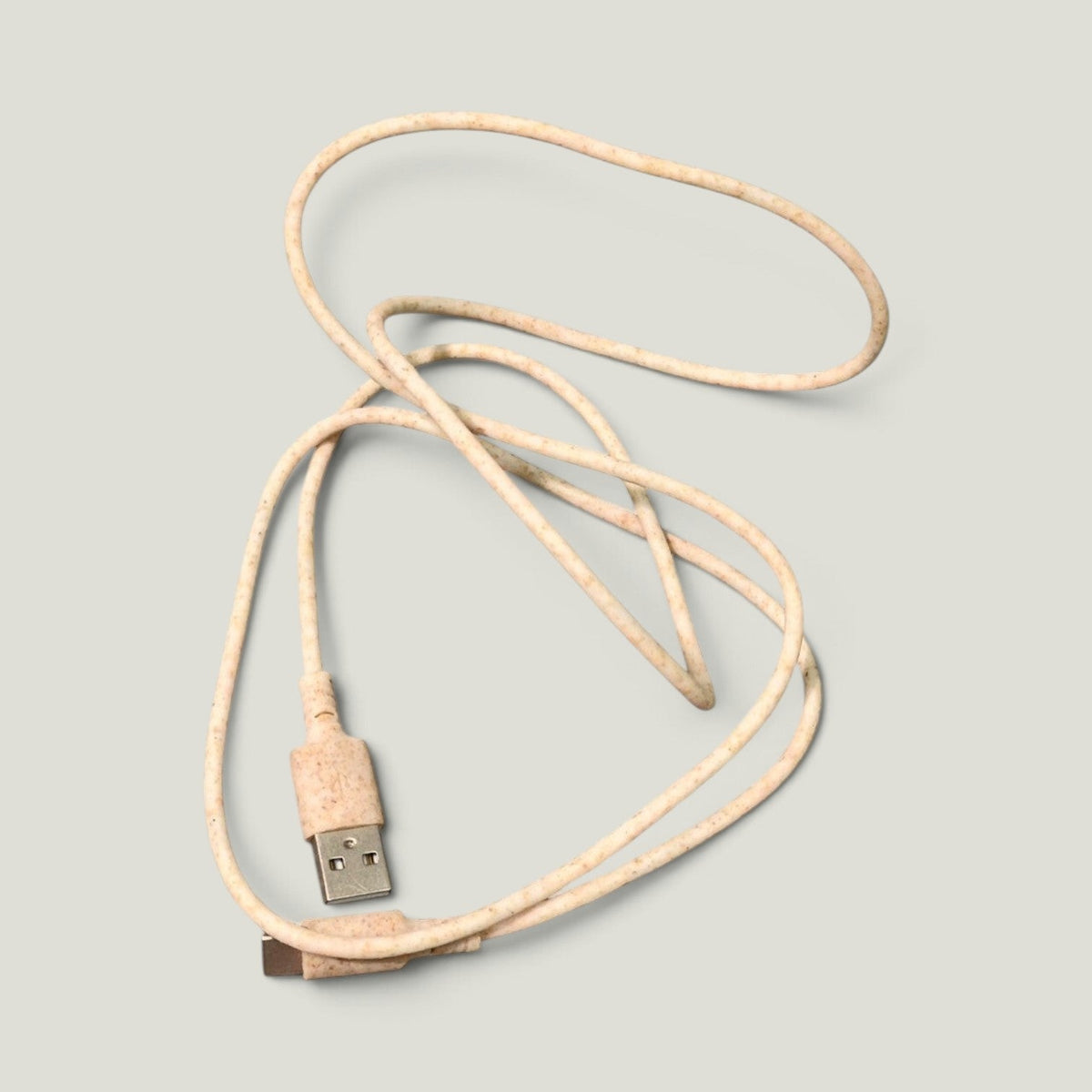 We Pure 1m USB-C charging cable made from eco-friendly beige wheat straw plastic with a textured speckled finish.
