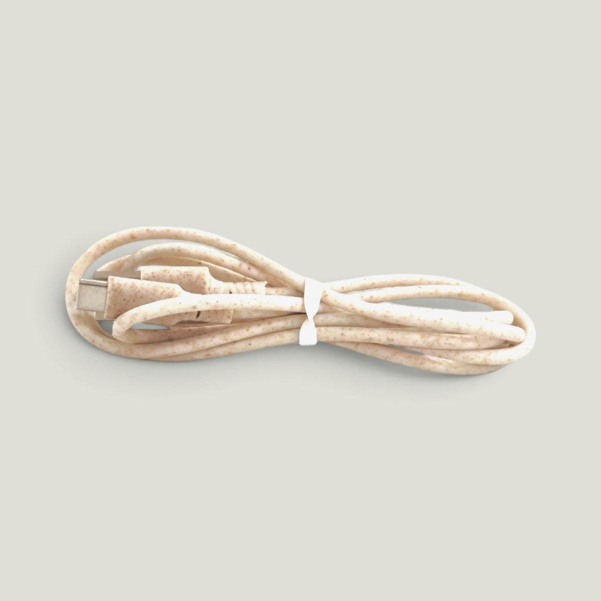 We Pure 1m USB-C charging cable made from sustainable beige wheat straw plastic with a speckled texture.